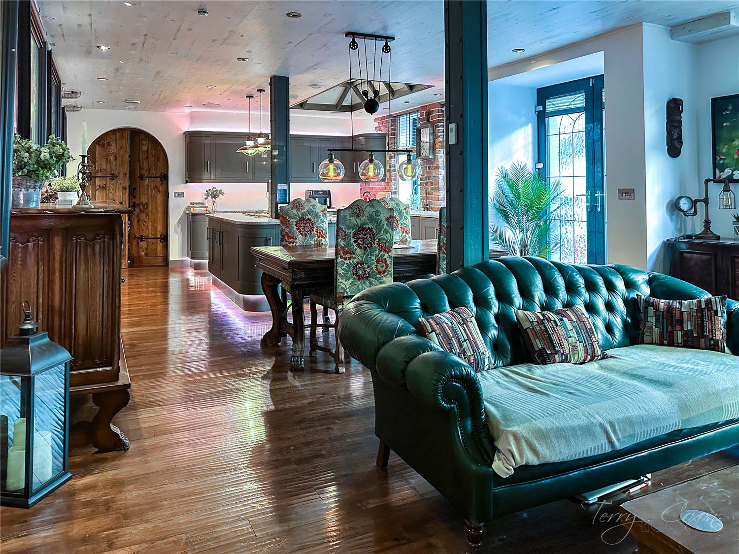 View towards the kitchen island over the green sofa back